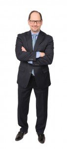Full length portrait shot on white seamless backdrop of Lloyd Cooper, a top-performer with Cushman & Wakefield