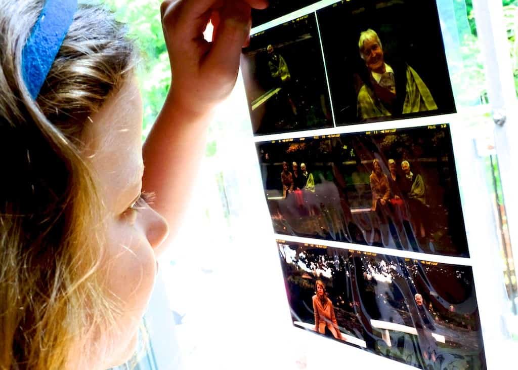 Image of girl looking at negatives from old 8x10 camera