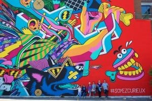 people-in-front-of-giant-wall-graffitti