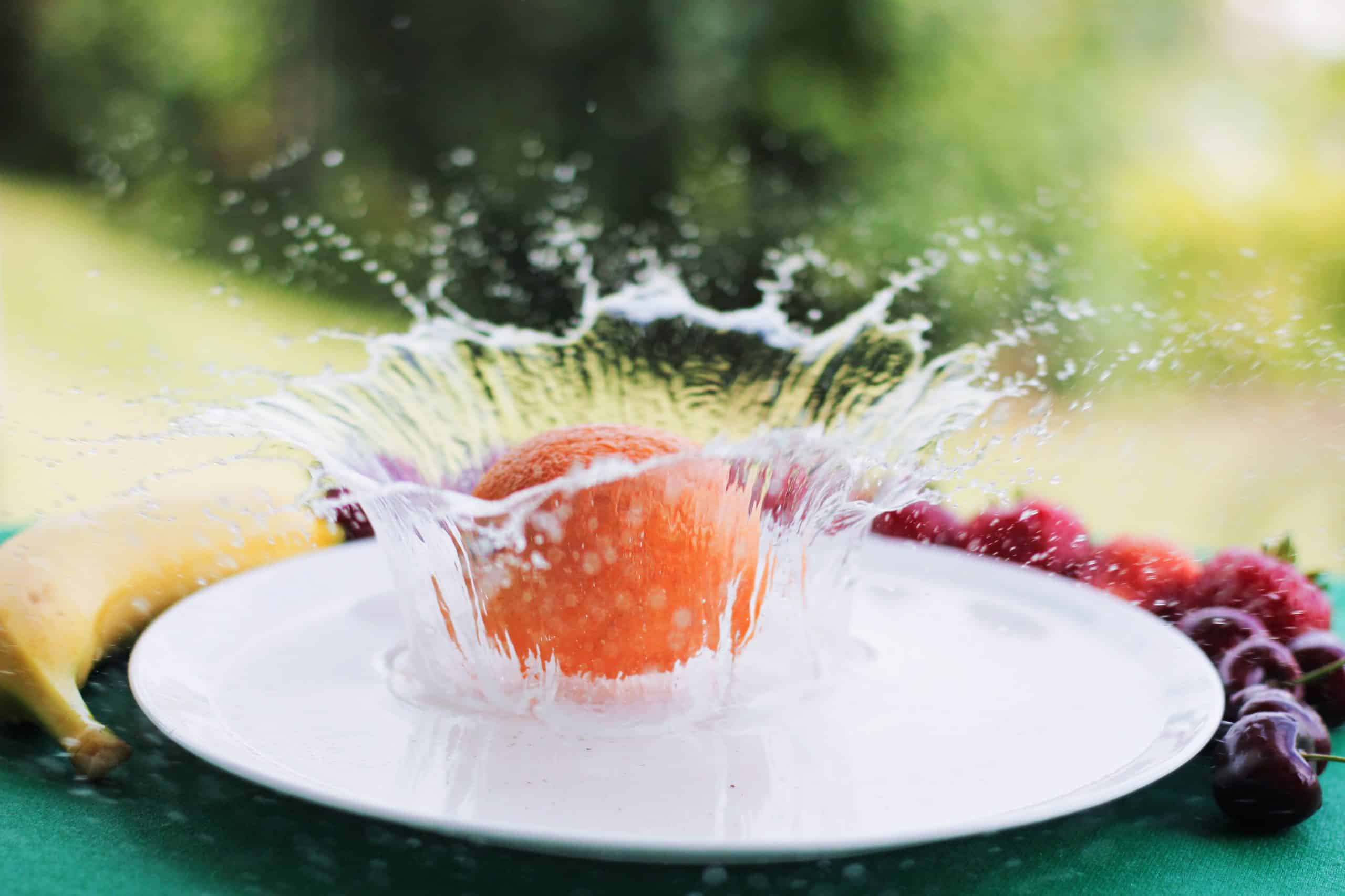 Orange splashing in water Orange splashing in water