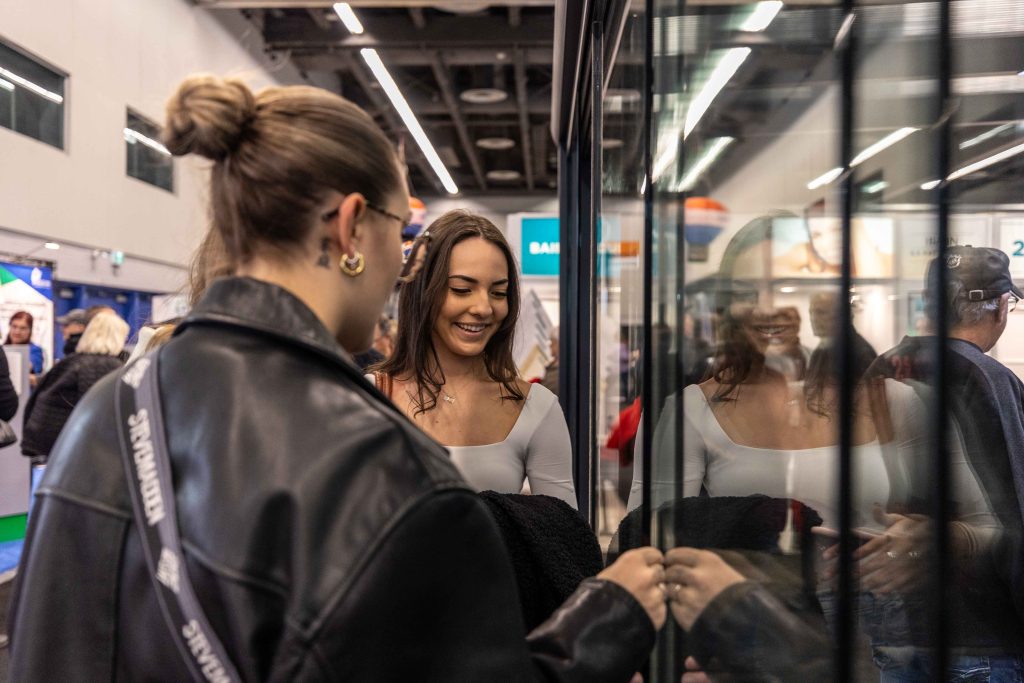 salon-habitation-photos-JulianHaber woman looking at demonstration sliding door at a home decor and renovations trade show