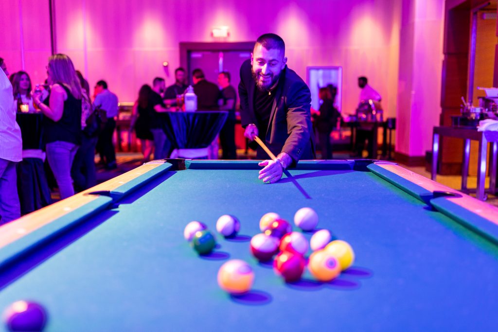 Brother-20230503-AA8A1070 man playing pool at company event