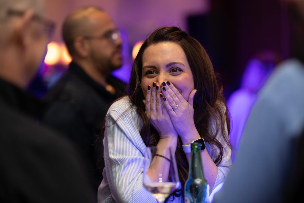 Brother24-NatCon - Credit Julian Haber-20240508-602A0120 Women looking surprised and excited covering her mouth with ehr hands photographed by Montreal event photographer, Julian Haber.