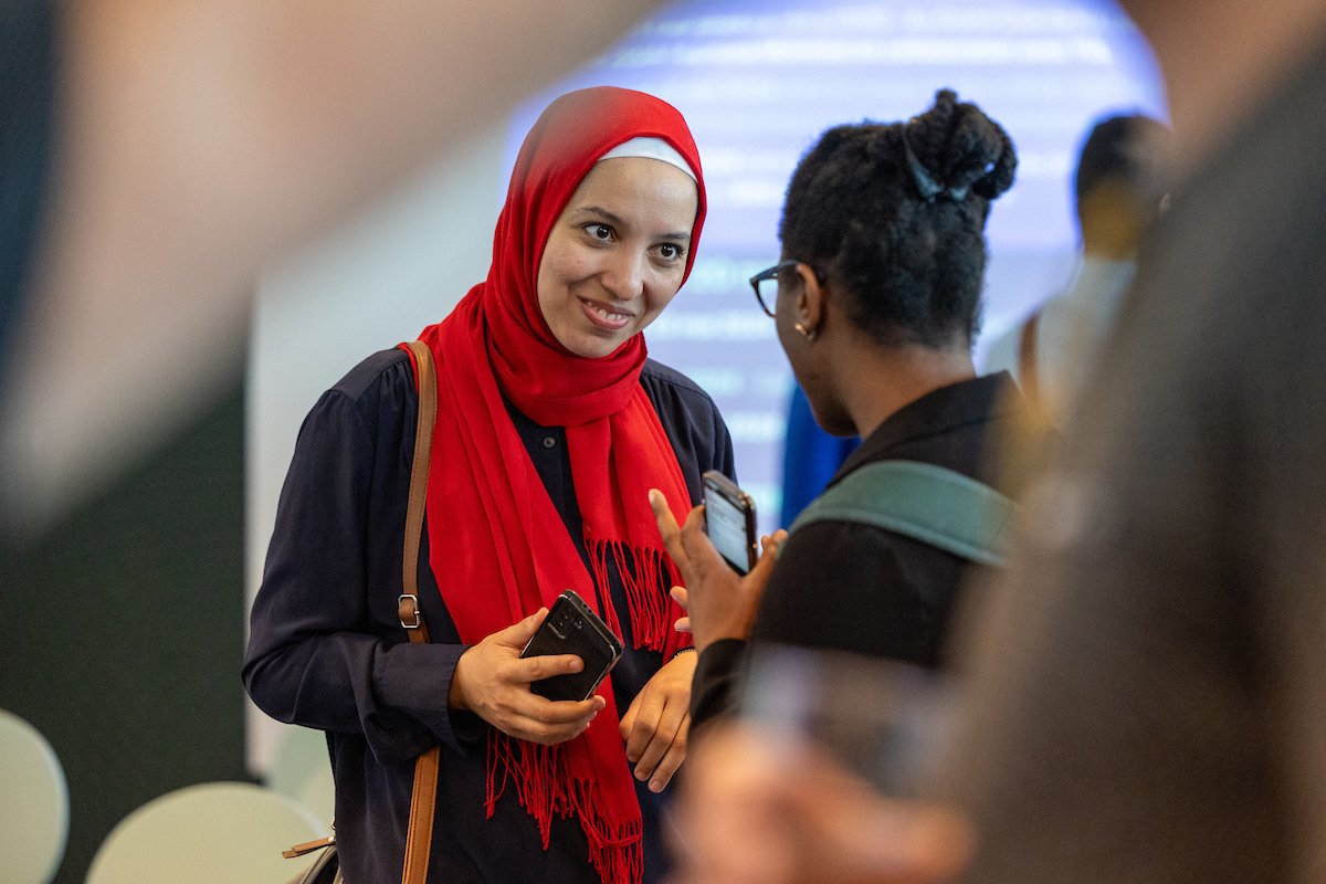 StartupOpenHouse 2024-Credit Julian Haber-20240523-602A1827 Woman wearing red hijab conversing with a Black woman at a networking event #eventphotography #MontrealConferencePhotography