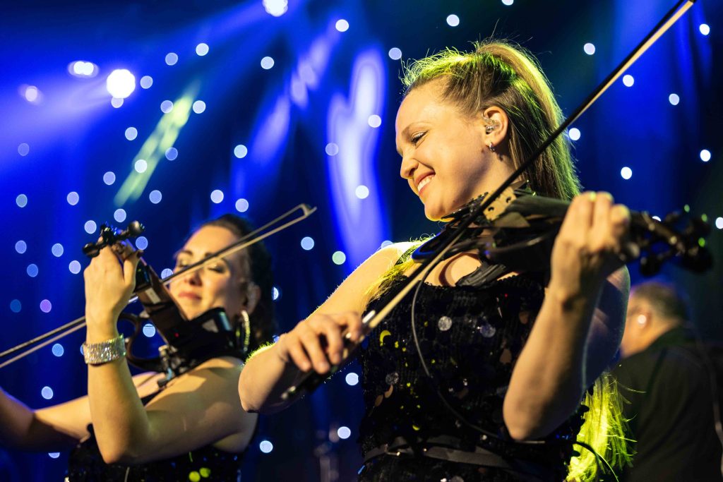 Credit JULIAN HABER-20241219-0111 Smiling woman playing electric fiddle