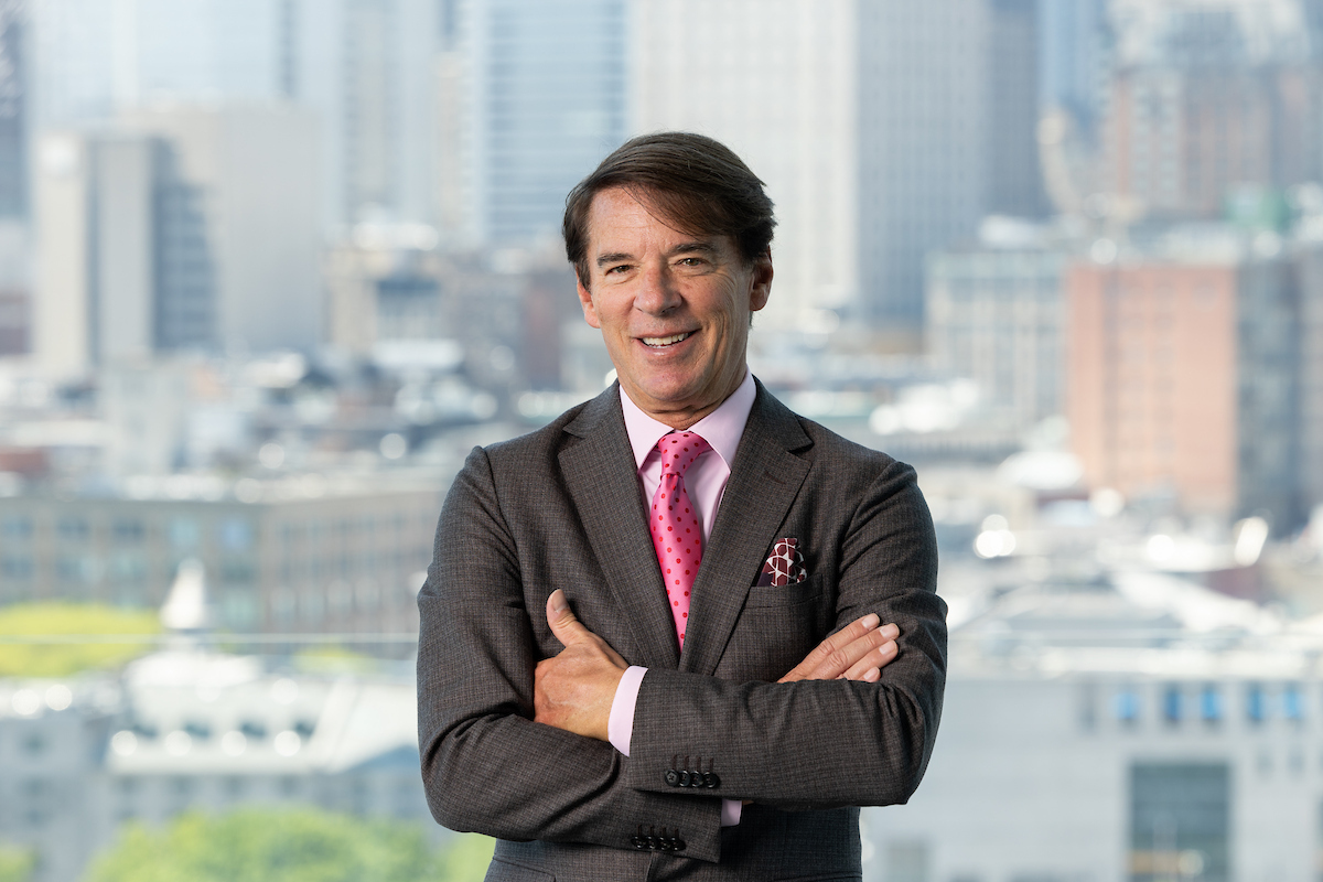 Business portrait man in suit and tie in front of window with a view by Montreal corporate portrait photographer Julian Haber
