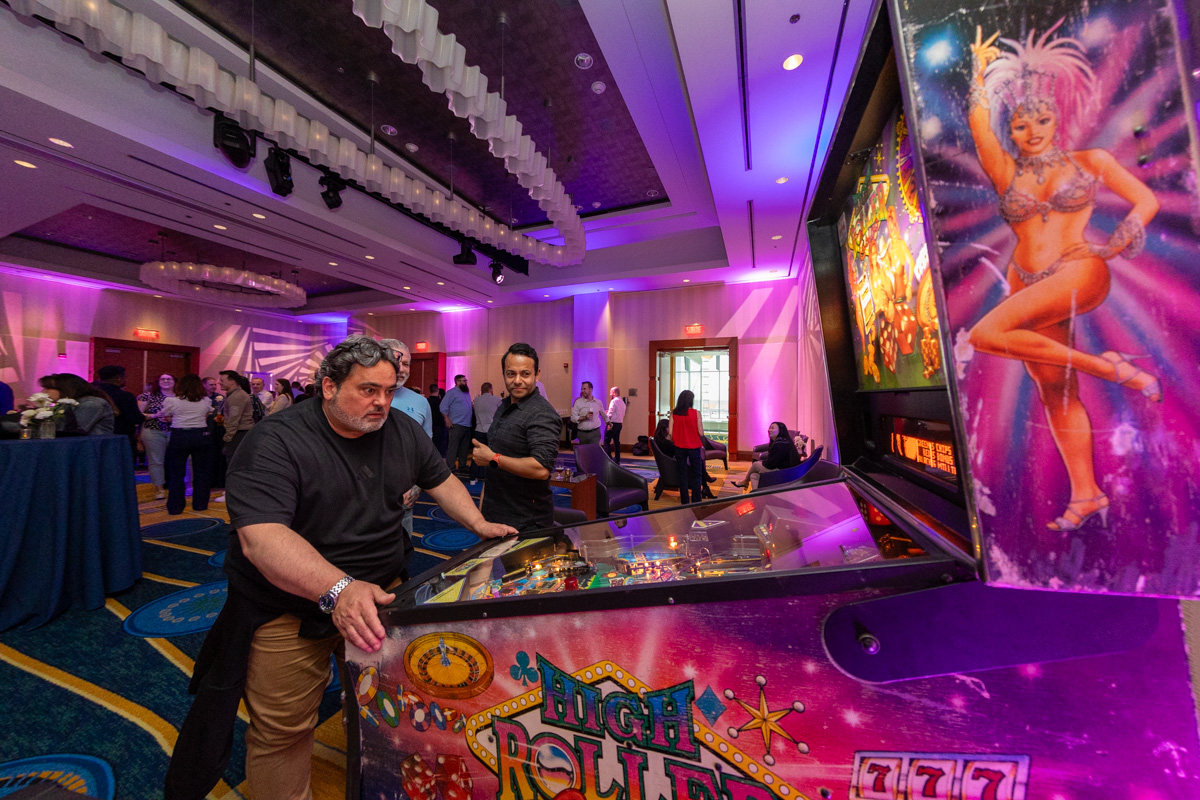 julian-haber-gala-event-lighting-atmosphere-montreal High-energy gala event photography featuring purple ambient lighting and man playing pinball at professional networking event in Montreal — Julian Haber