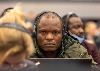 A delegate from the DRC listening to proceedings moments before raising an opposition at UN COP15, by Julian Haber.