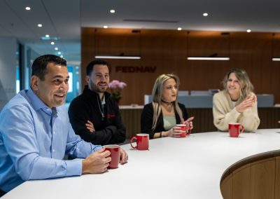 Julian Haber captures a team of employees collaborating over coffee at Fednav Montreal, illustrating a relaxed and approachable employer brand.
