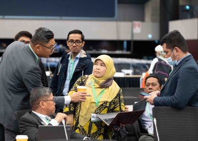 International delegates engaging in multicultural dialogue at the UN COP15 summit, captured by Julian Haber