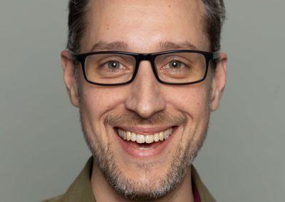 Corporate headshot of Intact Insurance employee - male professional in green.